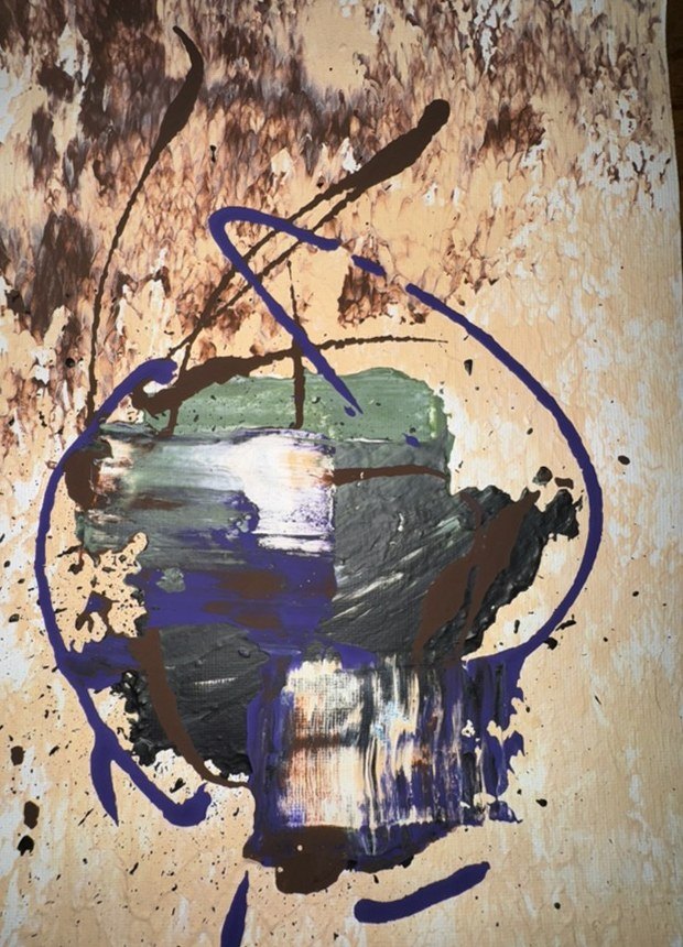 Splattered beige and brown paper with a purple loop around a grey-green block